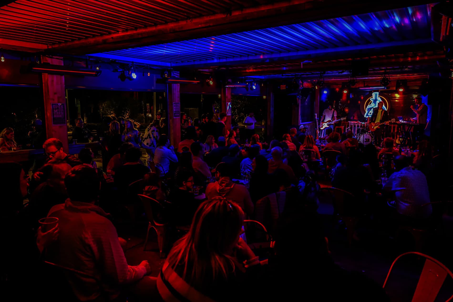 Musician performing on the MadLife Grill patio stage